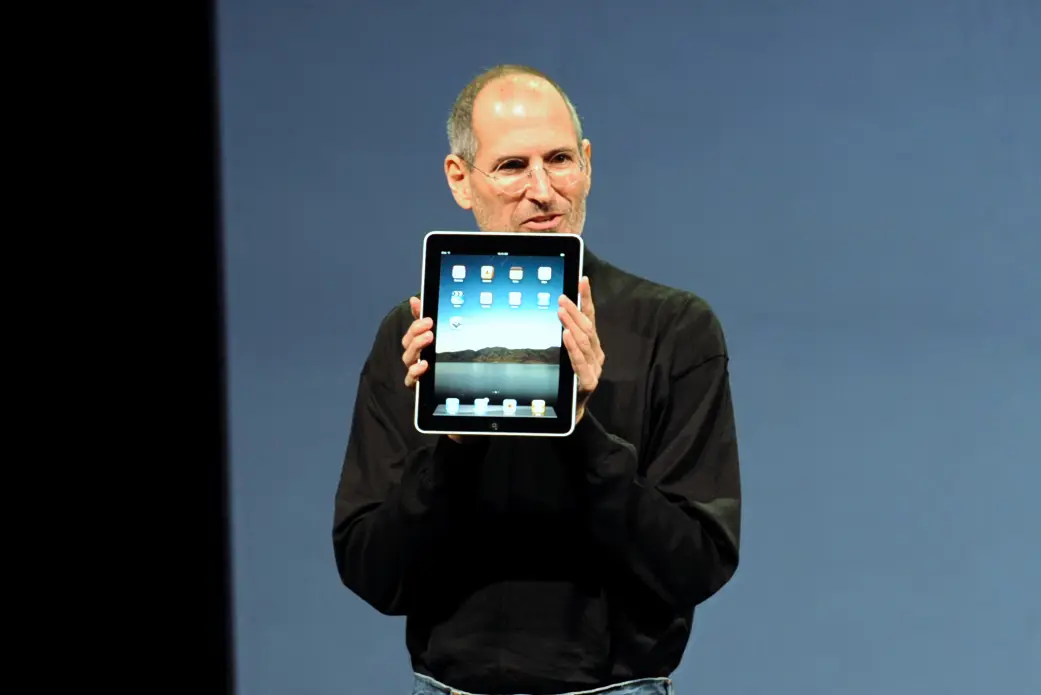 Steve Jobs holding an iPad